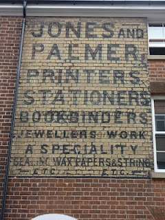 Hand painted sign on a building advertising Jones and Palmer