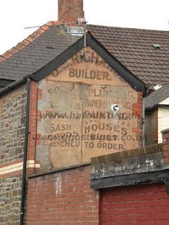 Hand painted advertisement on building for Richards Builders