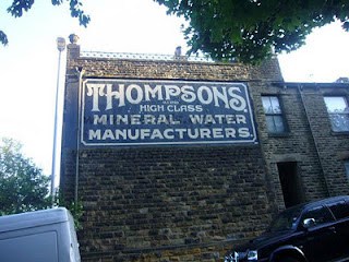 Hand painted sign on building for Thompsons Mineral Water