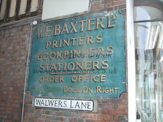 Hand painted sign on building for W.E.Baxter Ltd Printers Bookbinders Stationers