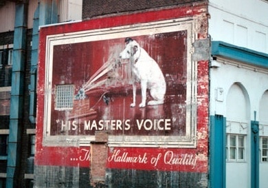 Hand painted sign on a building in Australia advertising HMV