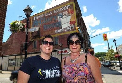 Project leaders in front of the repainted ghostsign in Cambridge, Ontario, Canada