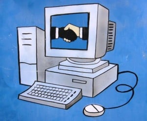 Painted illustration of a computer with a picture of hands shaking on the monitor
