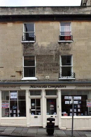 Hand painted sign on building in Bath showcasing the work of signwriter R. Boseley