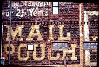 Hand painted sign on a wall for Mail Pouch Tobacco