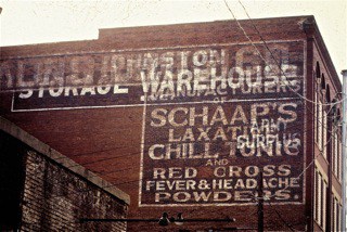 Hand painted sign on a wall advertising Schapp's Laxative