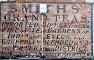 Hand painted sign on a wall advertising Smiths Grand Teas