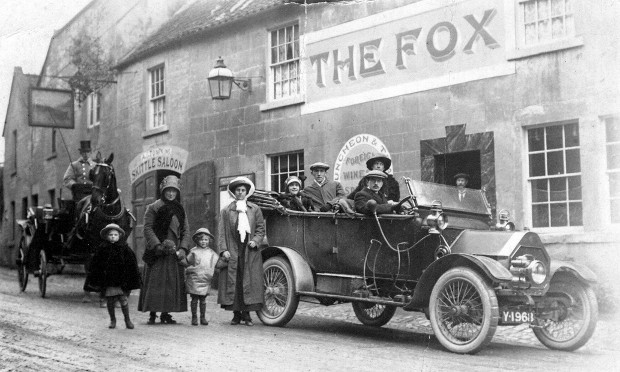 Early 1900s photo of family and car outside tavern called The Fox