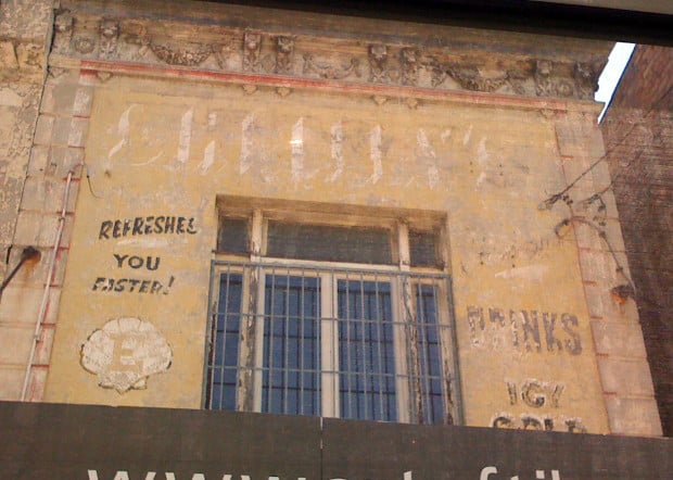 Ghostsign for Shelley's drinks painted around the border of a window