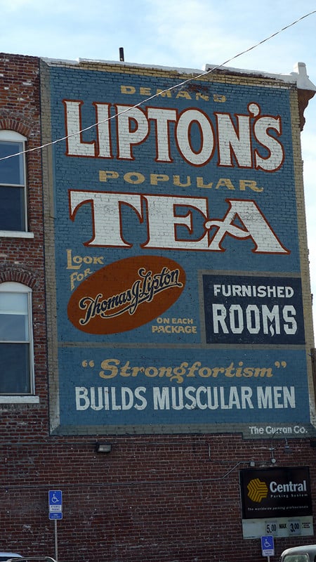 Large sign on a wall advertising Lipton's Tea