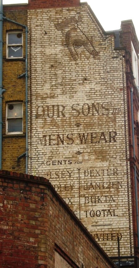 Fading painted sign (ghostsign) for Our Sons Menswear