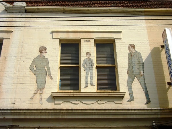 Painted figures on a wall advertising a clothing retailer
