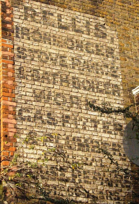 Painted sign on a wall advertising R Ellis, Ironmonger