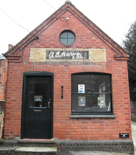 Fading painted sign on a wall for A.E. Harvey & Son