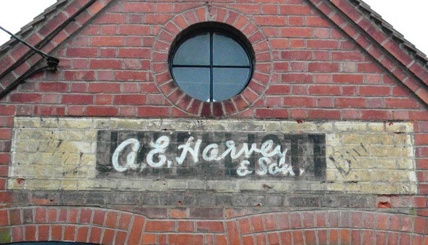 Fading painted sign on a wall for A.E. Harvey & Son