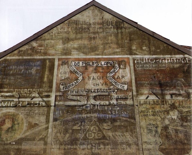 Various faded advertisement on a wall