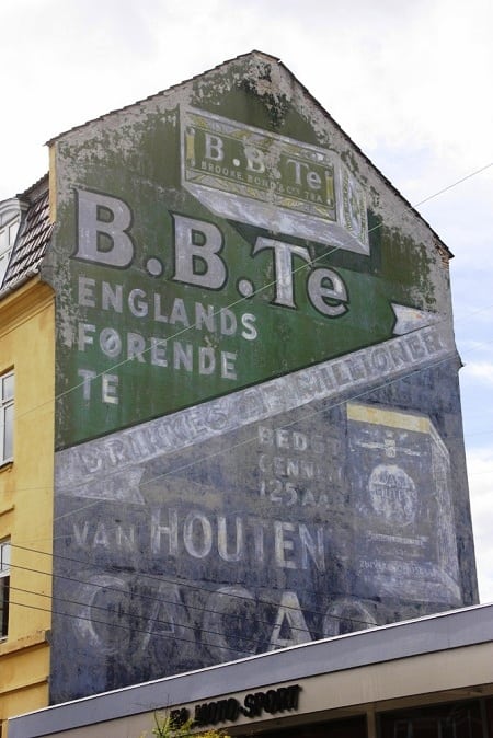 Two fading painted signs advertising B.B.Te and Van Houten Cacao