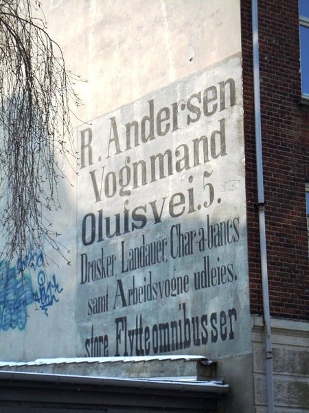 Fading painted advertisement on a wall for R Andersen