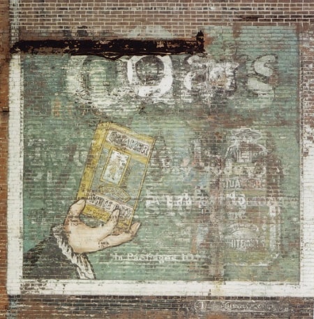 Fading painted advertising for Quaker Oats on a wall