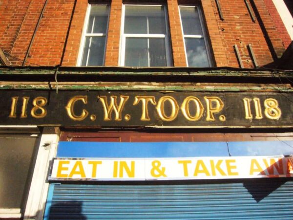 Carved and painted (perhaps gilded) shop front for C.W.Toop