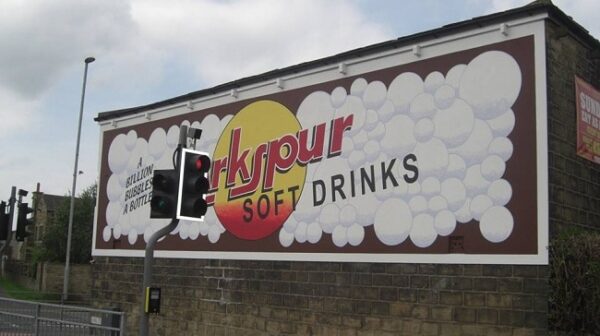 Restored painted sign on a wall for Larkspur Drinks