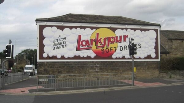 Restored painted sign on a wall for Larkspur Drinks