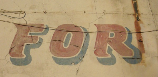 Detail of painted sign showing the word 'For'
