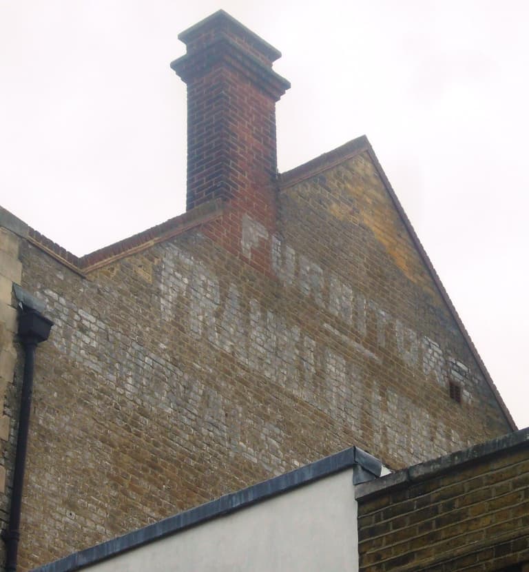 Fading sign on wall for a furniture/removals company