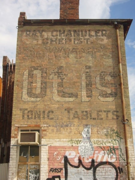Painted sign fading on a wall advertising DeWitt's Otis Tonic and Tablets