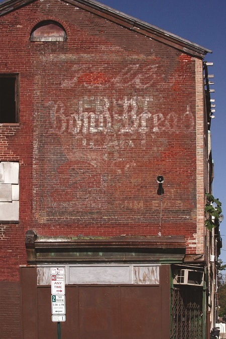 Fading advertisement on a wall advertising Kolb Bread, Bond Bread & Others