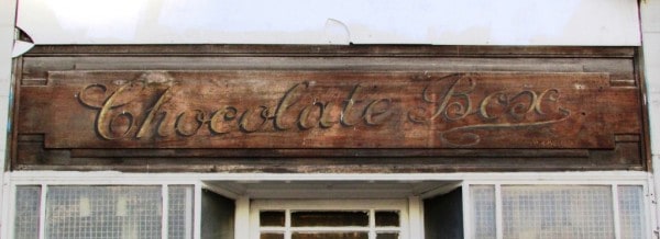 This is a recent fascia reveal with some lovely script lettering on a specially shaped board. Not quite visible in this photo, the bottom right of the sign also has the text 'Prop A.Inglesent' indicating the chocolate box's owner. The sign is on university grounds and will hopefully be removed for display while the rest of the building is redeveloped.