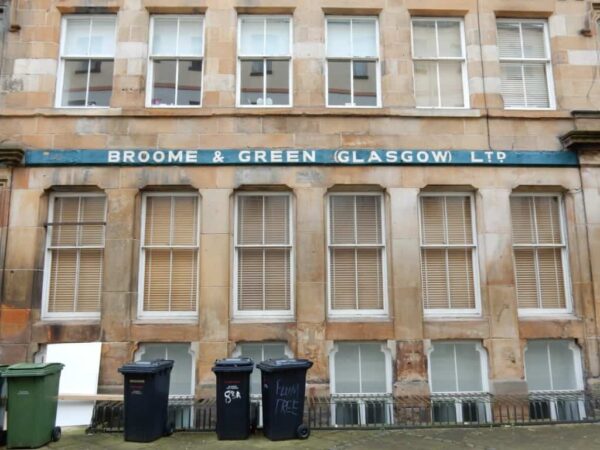 Painted sign for Broom & Green above ground floor windows