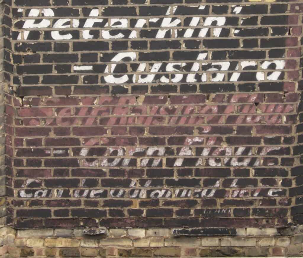 Detail of Peterkin Custard ghost sign in Battersea.