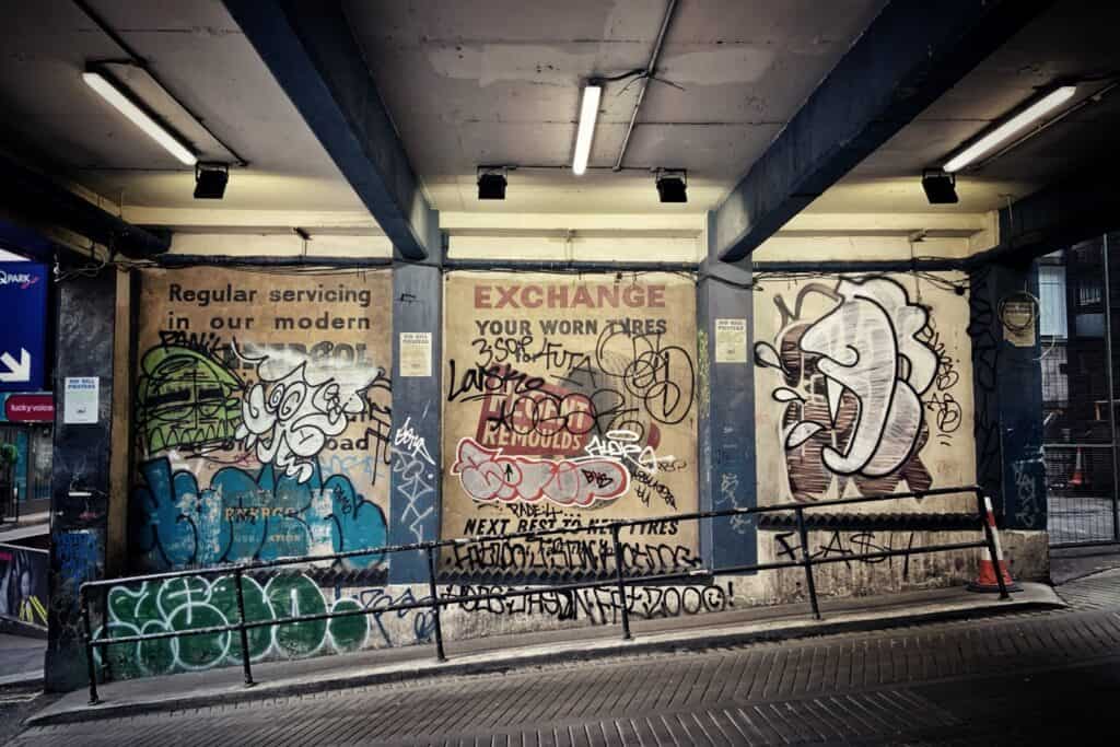 Painted signs covered by graffiti.