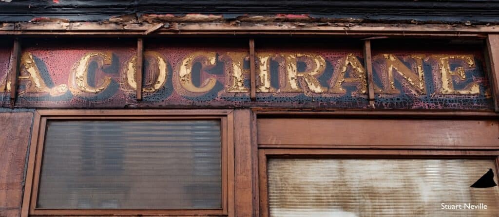 Fading painted shopfront for A. Cochrane.