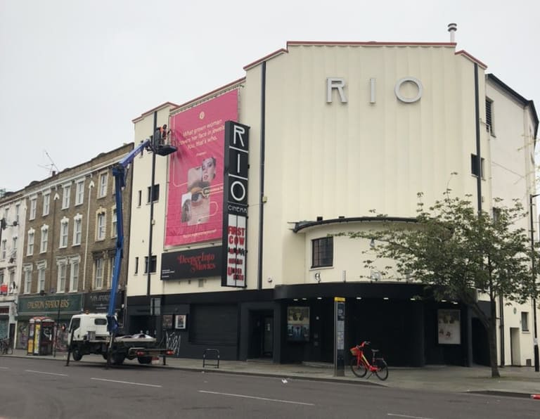 Banner installed on front of listed Art Deco cinema facade.