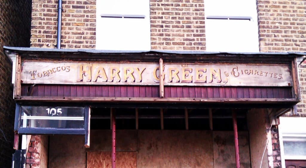 Fading painted shop front from Harry Green, Tobaccos & Cigarettes