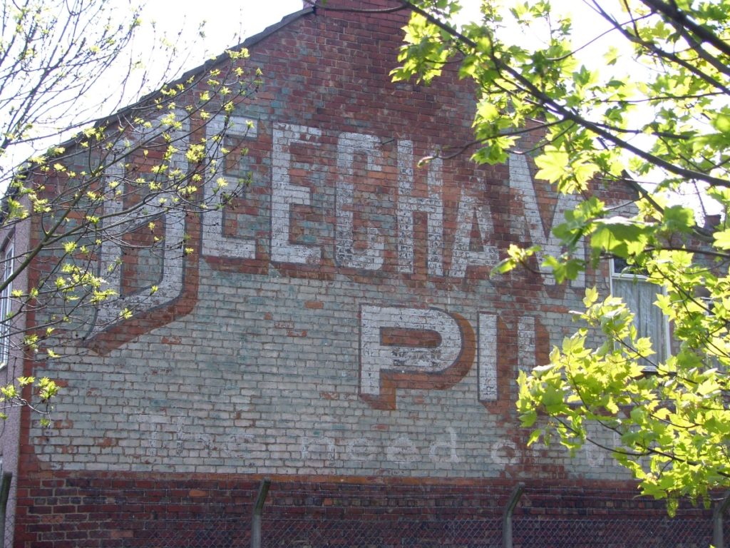 Painted Beecham's sign on gable end.
