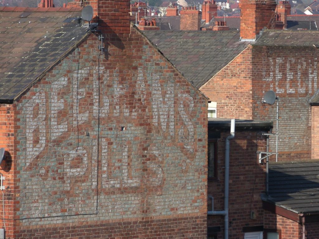Painted Beecham's signs on gable ends.