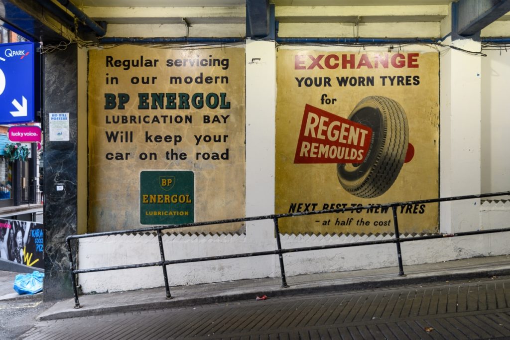 Two painted signs after restoration.